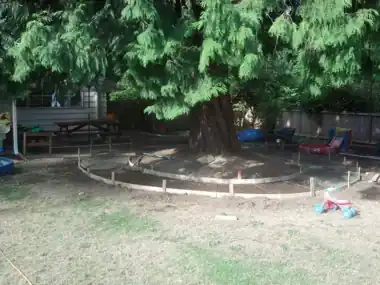 Circular Kids' Bike Track Around a Tree: concrete patio and wall work by Redmond Concrete, concrete contractor serving Kirkland (photo 3 of 6)