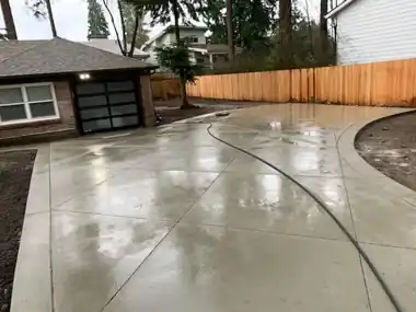Curved Driveway along Cedar Fence: concrete driveway work by Redmond Concrete, concrete contractor serving Bothell (photo 2 of 2)