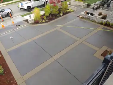 Driveway with Decorative Tan Bands: concrete driveway work by Redmond Concrete, concrete contractor serving Bothell (photo 1 of 2)