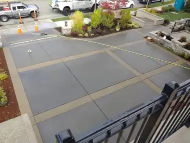 Driveway with Decorative Tan Bands: concrete driveway work by Redmond Concrete, concrete contractor serving Woodinville (photo 2 of 2)